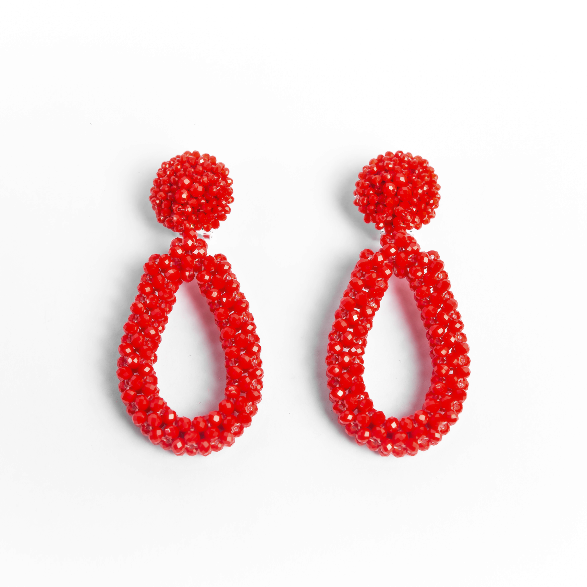 Pair of red beaded earrings on a white background