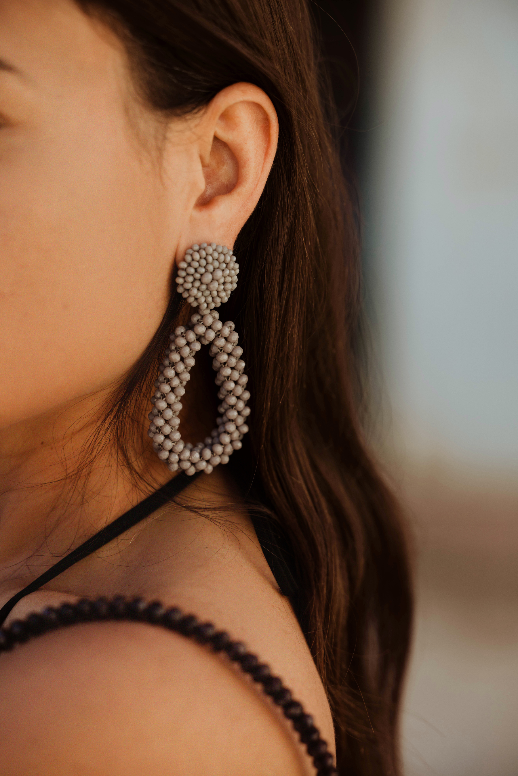 Pair of sand beaded earrings on a white background