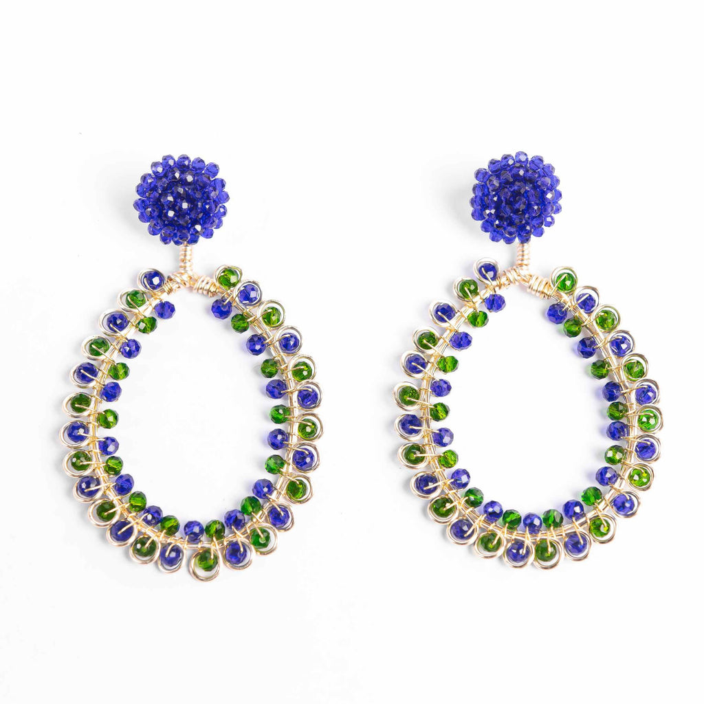 Pair of hoop earrings with blue and green gemstones on a white background