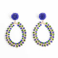 Pair of hoop earrings with blue and green gemstones on a white background
