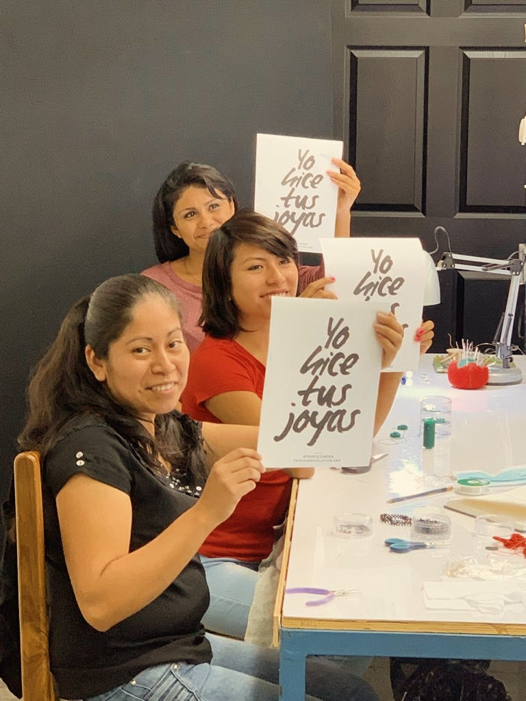 3 woman holding a paper that say " I did your jewelry"