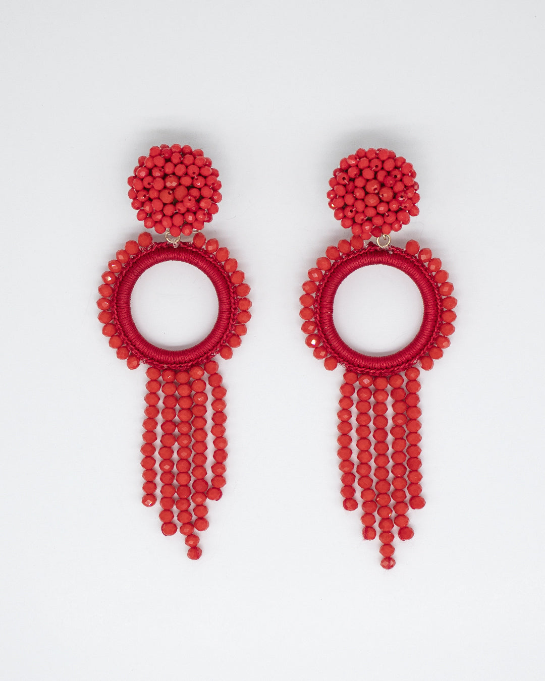 Red beaded earrings on a light gray background