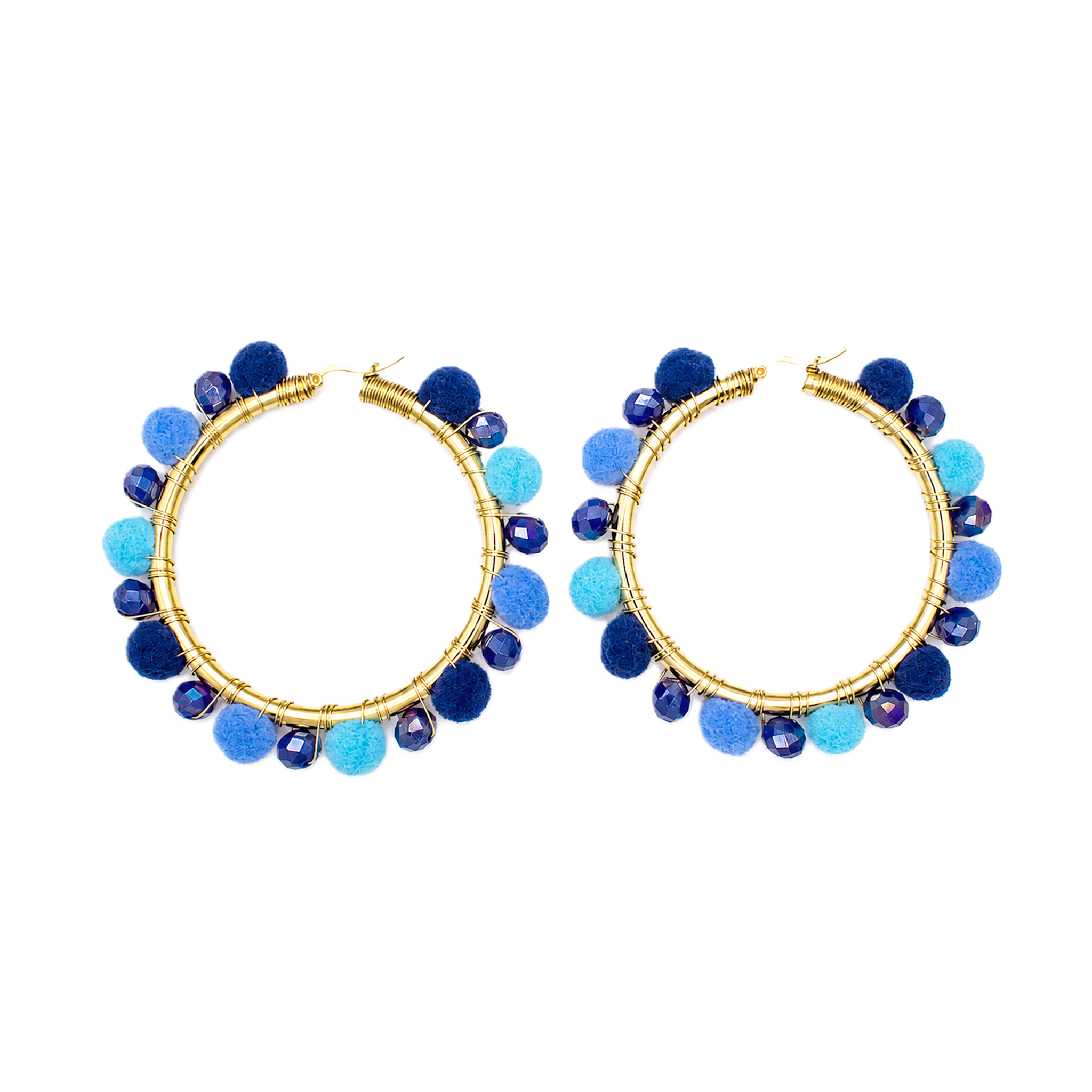 A pair of gold hoop earrings decorated with blue and light blue pom-poms and faceted beads, shown against a plain white background.